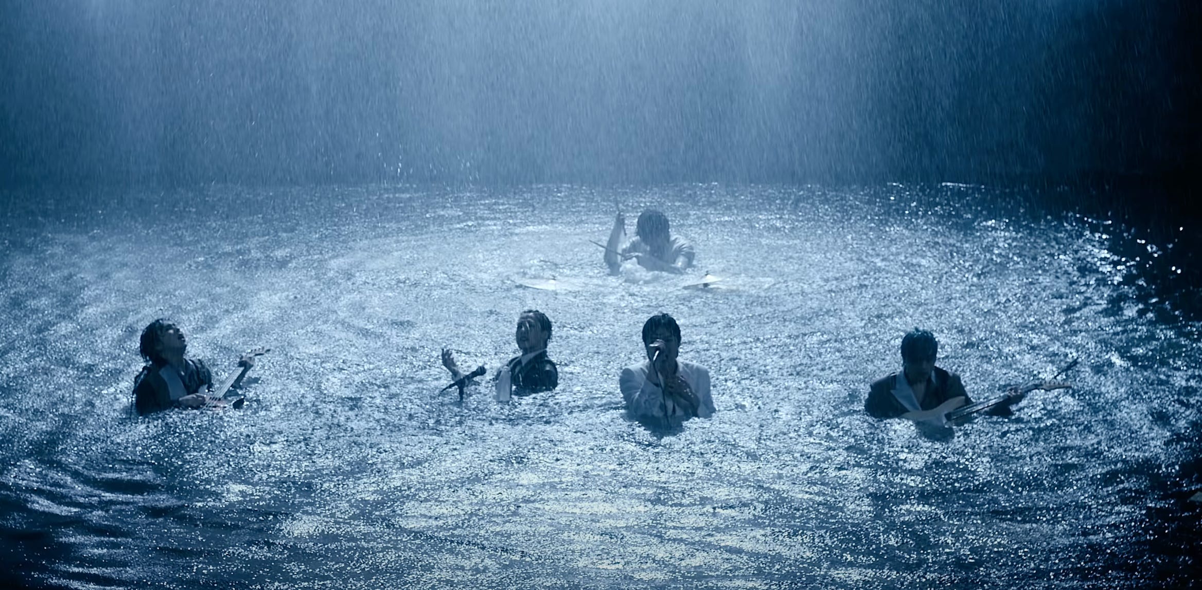 screenshot of music video featuring the five members of Onwew playing their instruments and performing with water up to their shoulders, flooding about to drown.