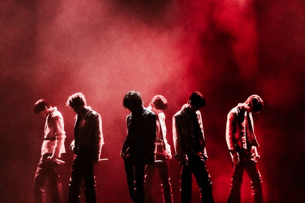 RIIZE on stage, shadowed in red and black